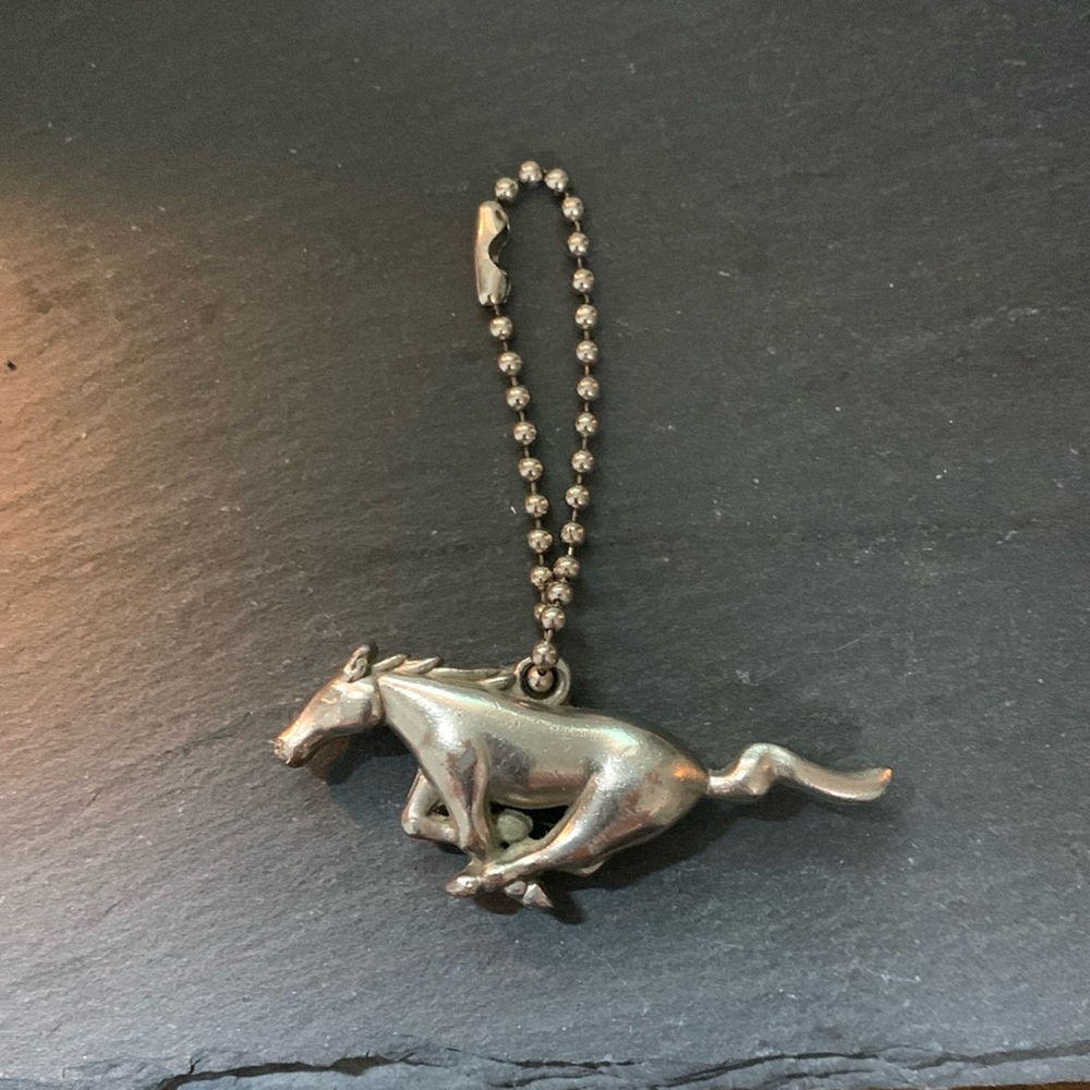 Silver tone galloping mustang